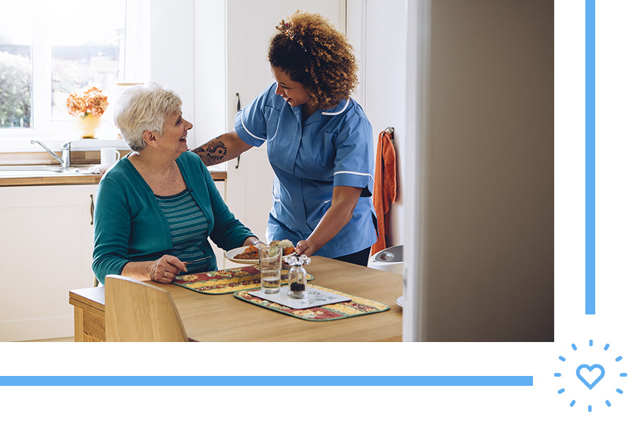 caretaker serving breakfast to grandmother