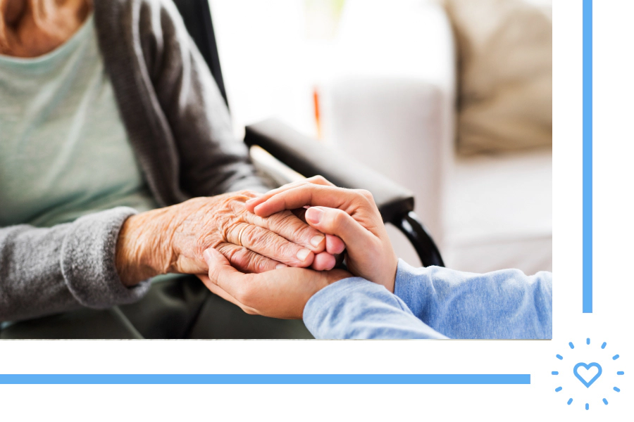 close up of a hand of an elder woman holding the hand of a caretaker newton ma